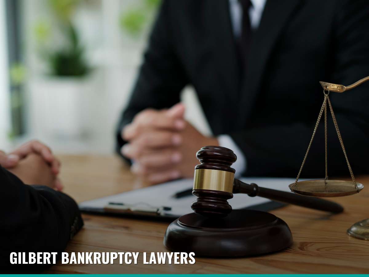 Arizona lawyer and client during a bankruptcy consultation with legal scales and gavel in the foreground